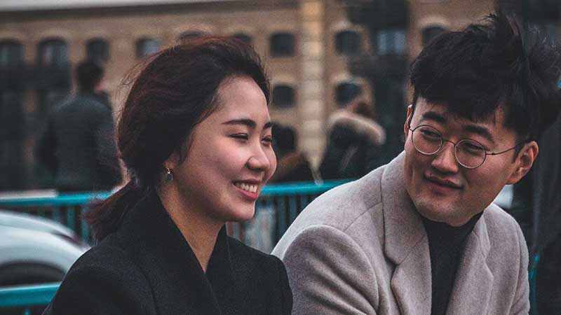 Man smiling at a woman