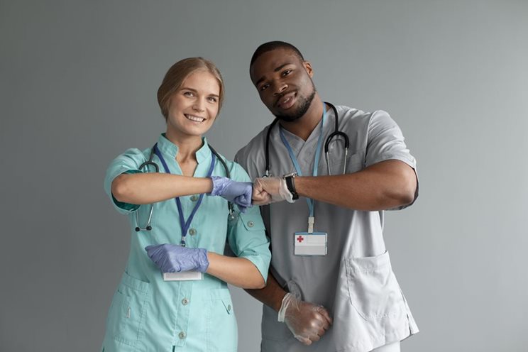 Nurses holding a globe.