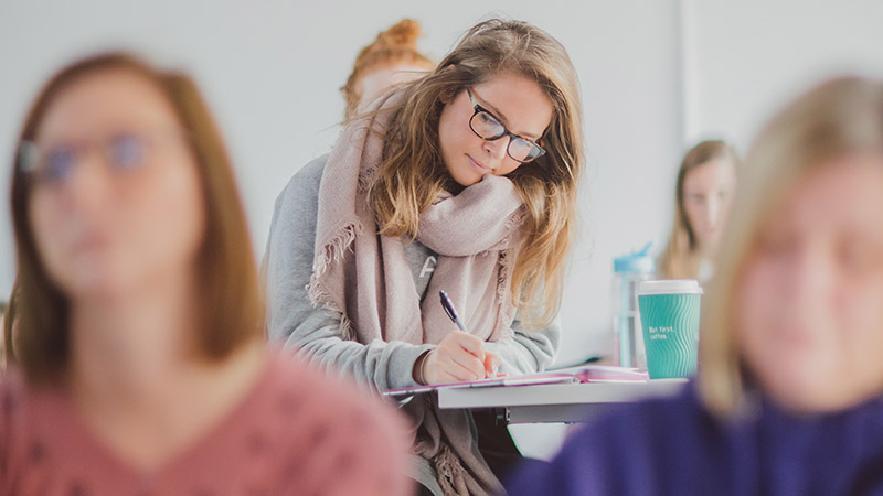 Student taking notes